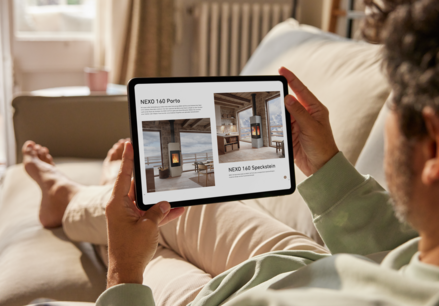 Man sitting on sofa browsing the Attika catalogue online on his iPad