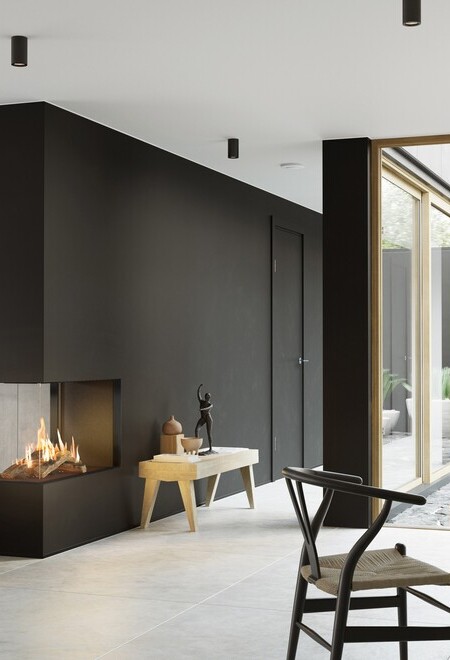 VISIO 90 RD gas fireplace fits perfectly as a room divider in a black wall between the living room and dining room and gives structure to the simply decorated living space