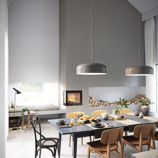 Wood fireplace insert R-600 two-sided as a centrepiece in the dining room with a set table