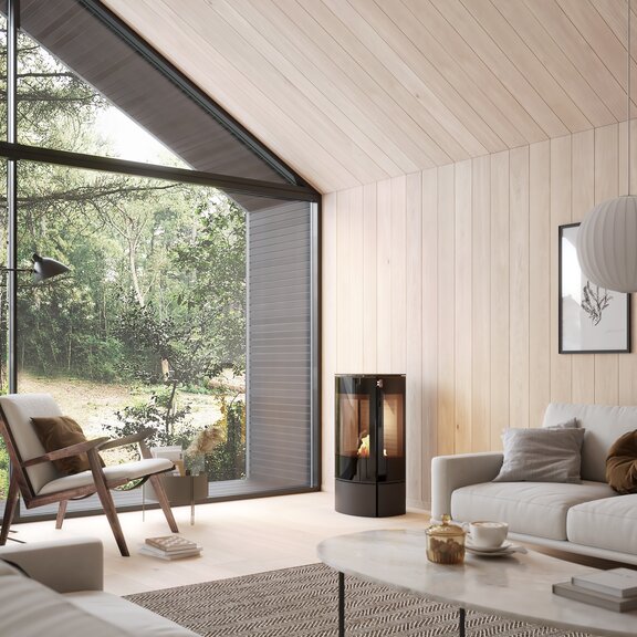 CARO 90 BIO bioethanol stove in black in a bright living room with lots of wood