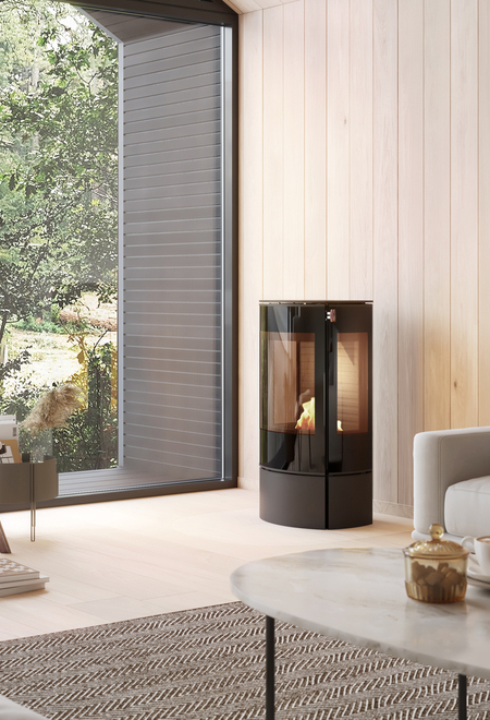 CARO 90 BIO bioethanol stove in black in a bright living room with lots of wood