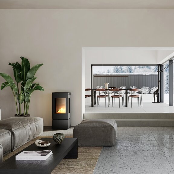 NEXO 100 BIO bioethanol stove in black in a living room with a sofa