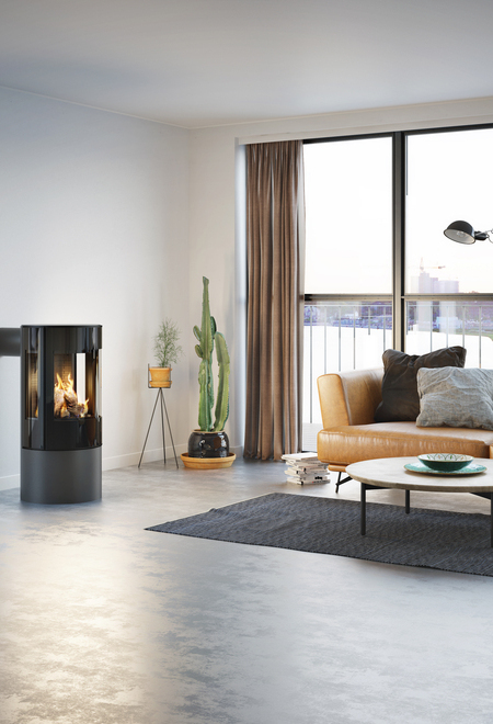 Gas stove VIVA 100 L in platinum with glass door in a minimalist flat with a view of the skyline