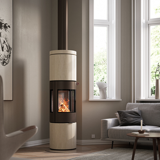 JUNO 166 L wood stove with natural stone Porto cladding and side windows in a modern living room in earth tones