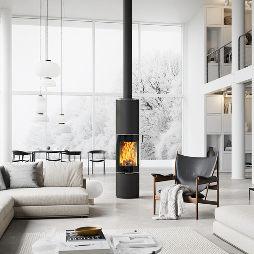 Wood stove PILAR in black with glass door as a rotating, round stove in the centre of a huge living room in Scandi style