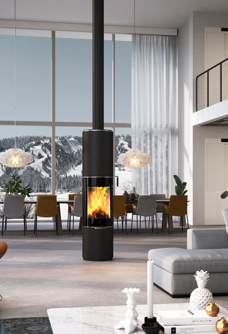 Wood stove PILAR in black with glass door as a rotating, round stove in the centre of a huge living room
