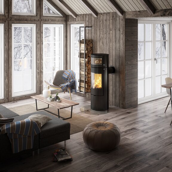 Wood stove VIVA L oven in black with integrated baking compartment, in which fresh bread is baked with the heat of the fire