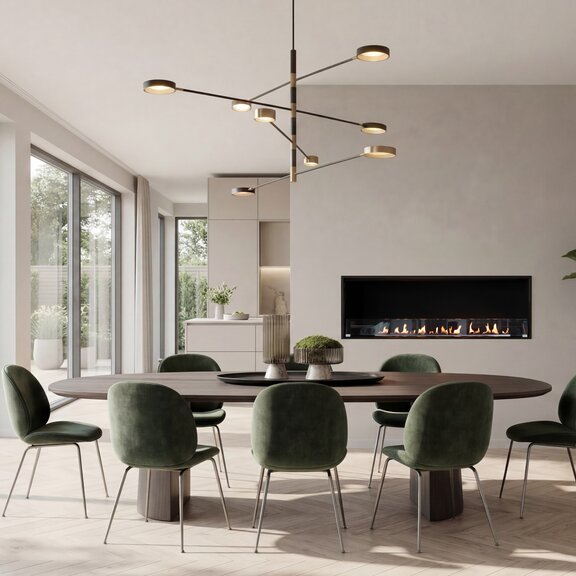 Montreal Front Bioethanol fireplace installed in the dining room, set against a white wall, with a large dining table and dark green chairs